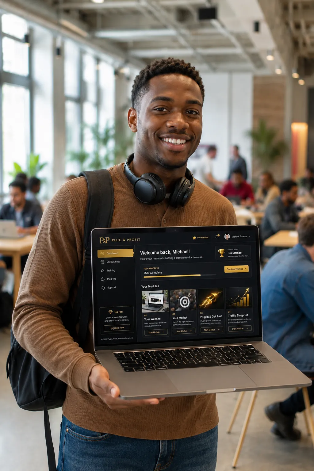 Man with a laptop smiling in a coworking space